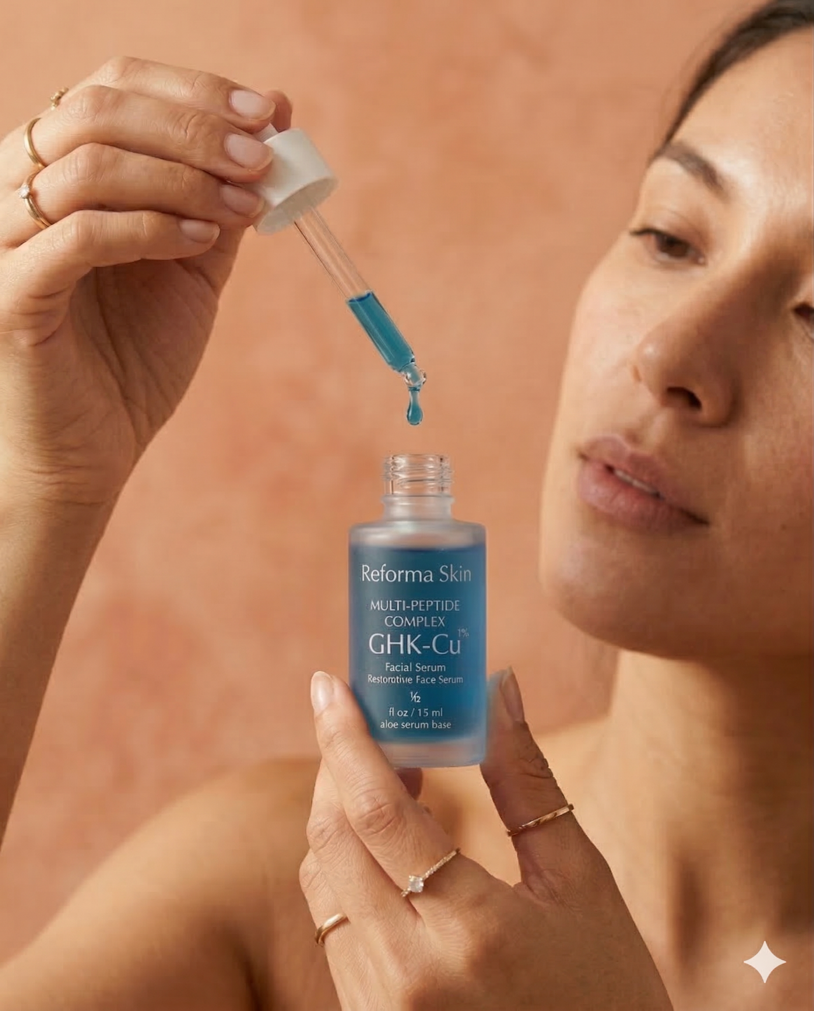 Woman applying serum drops to skin